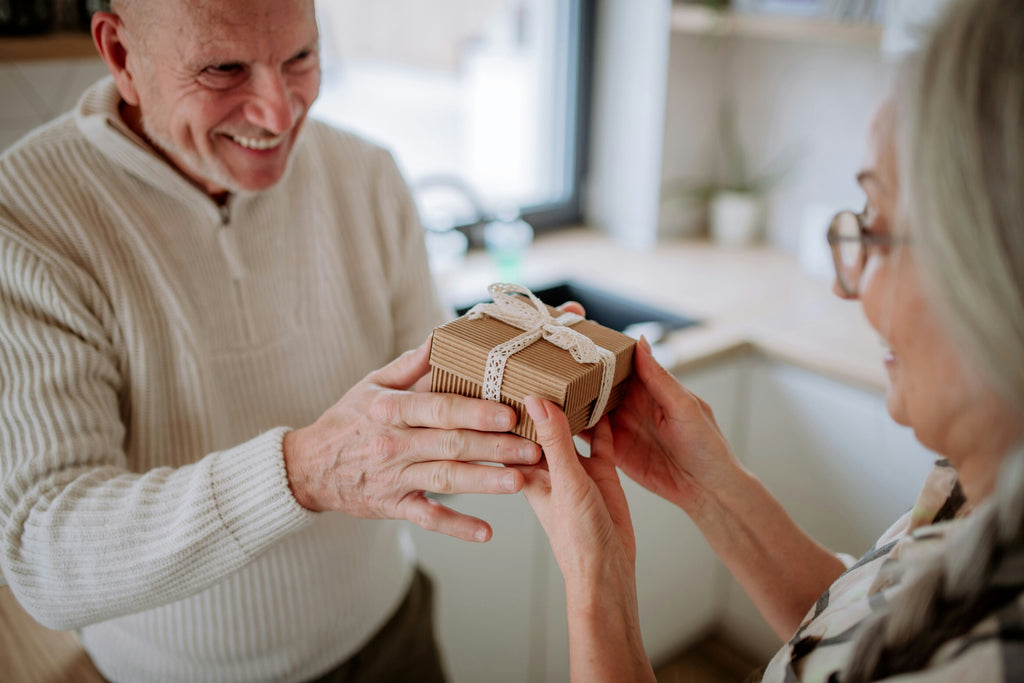 Valentine gift ideas - Senior man giving gift box to senior woman