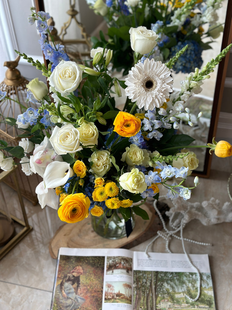 blue and yellow sympathy flower vase arrangement