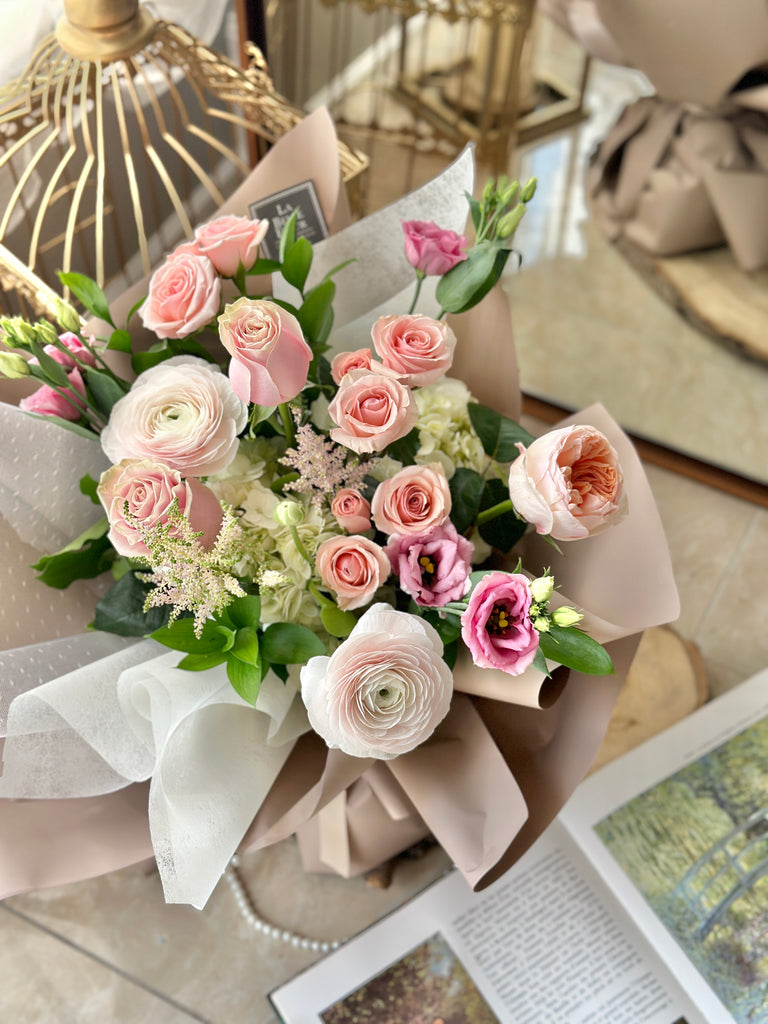 pink ranunculus bouquet with peach garden roses