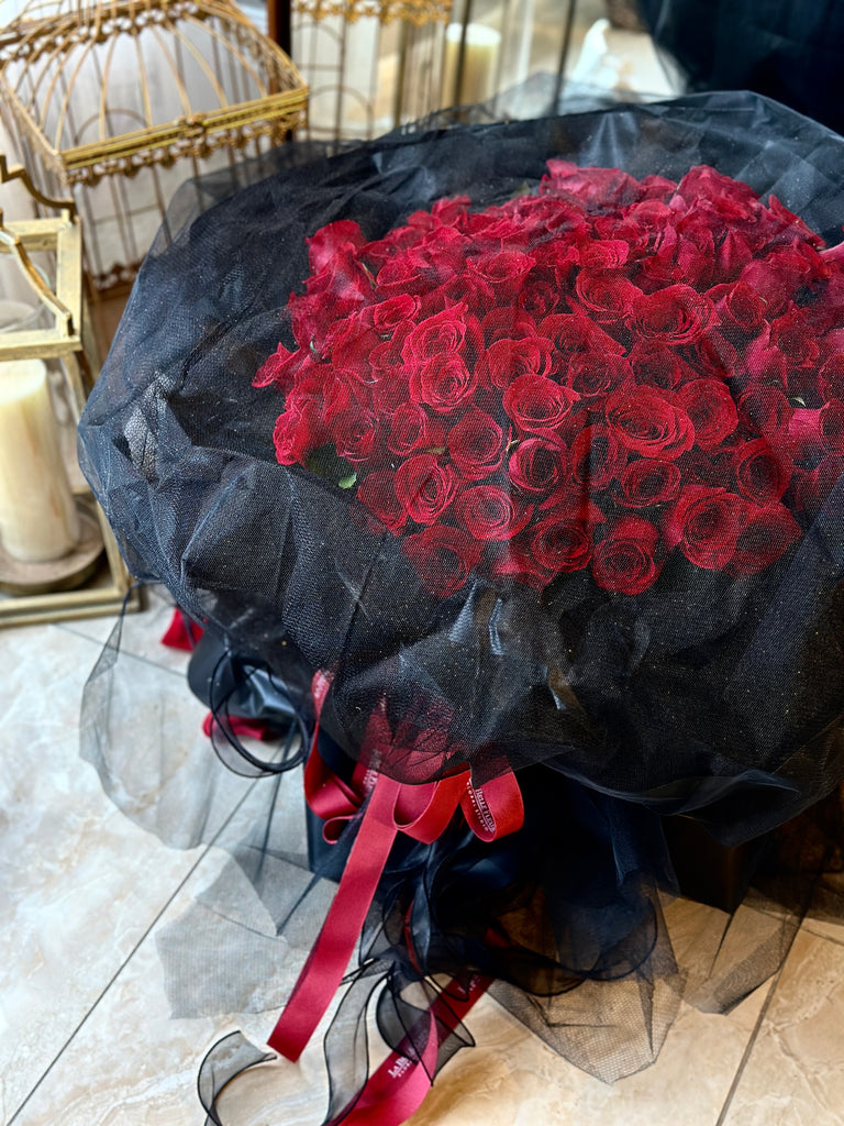 100 Red Roses bouquet with black mesh wrapping