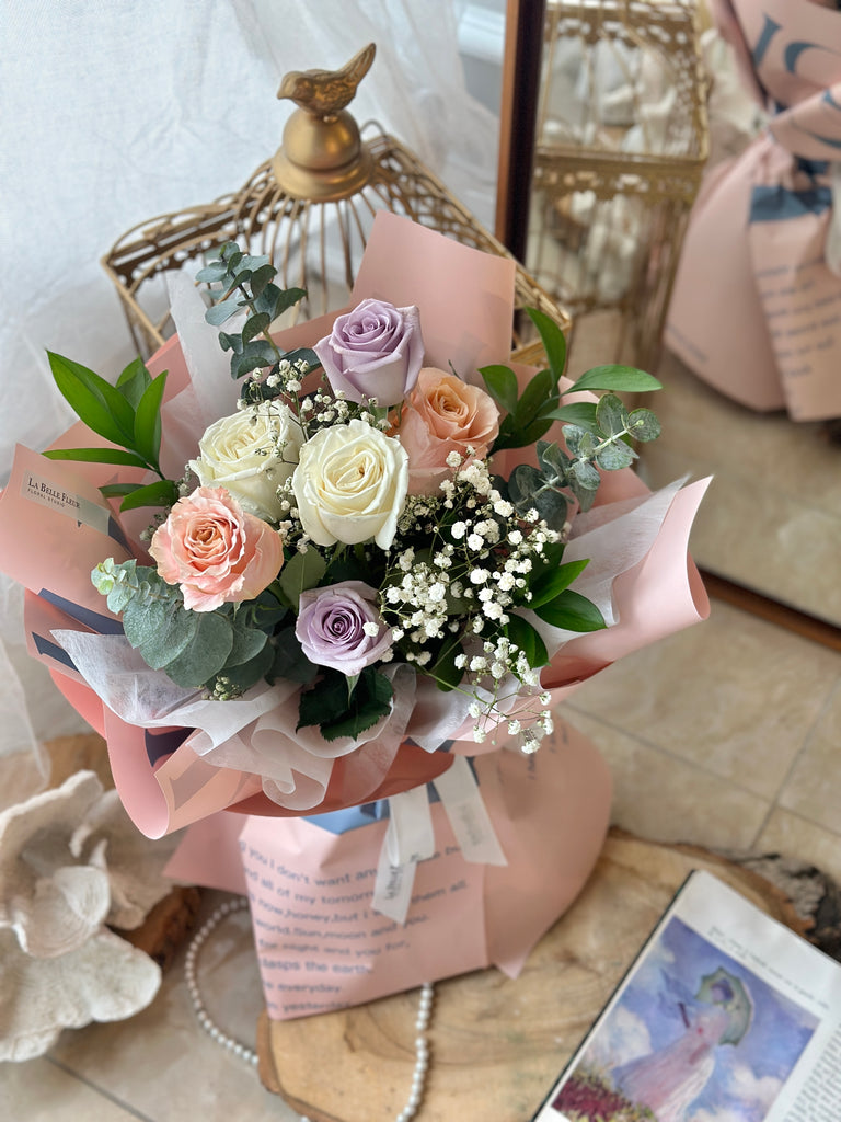 white peach lavender rose bouquet with pink wrapping