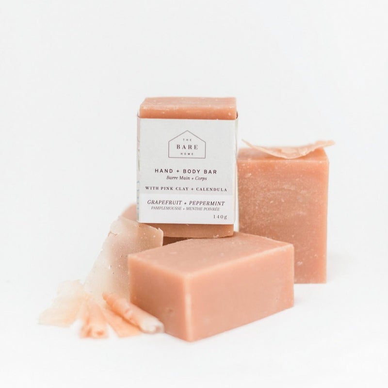 This image depicts The Bare Home Hand & Body Bar, a vegan soap crafted with Calendula oil, Coconut oil, Shea Butter & Cedarwood essential oil. Experience spa vibes at home!