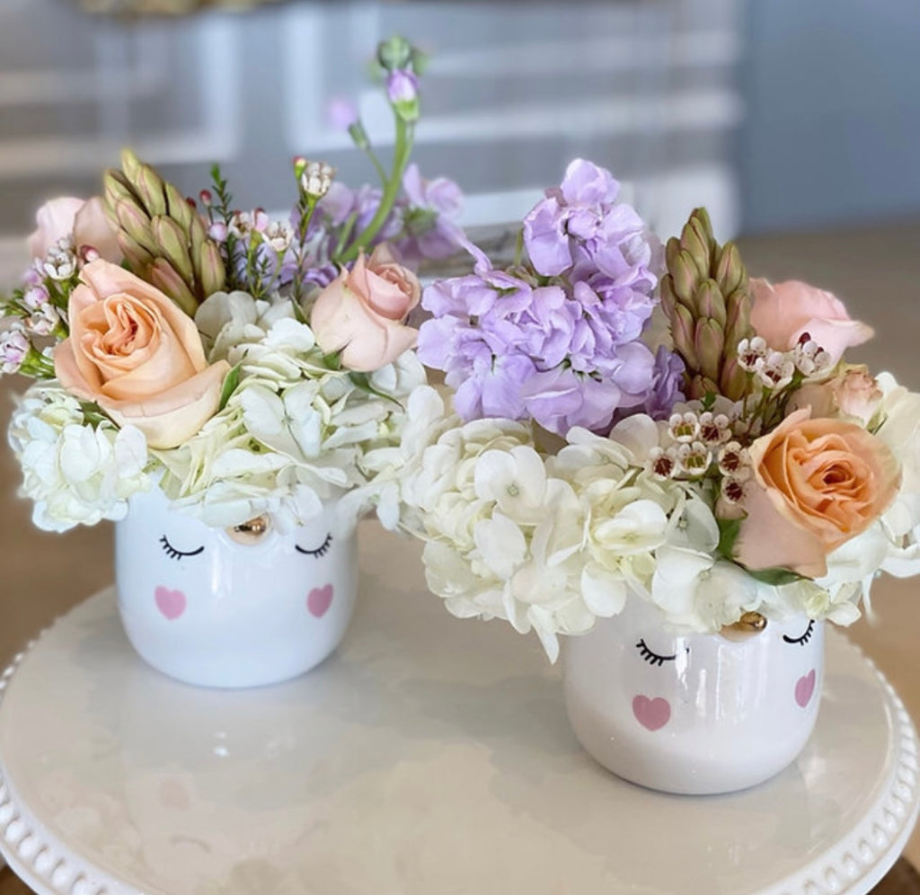 pastel flower arrangement in unicorn vase