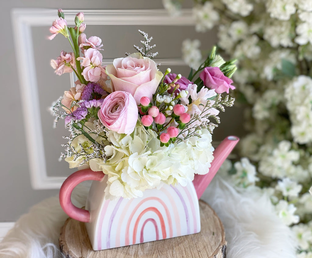 Good day flower arrangement in pink watering can