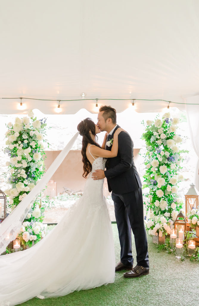two people kissing with arch flowers on the background