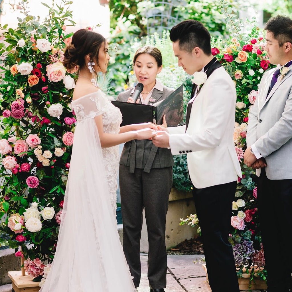 wedding ceremony with arch flowers