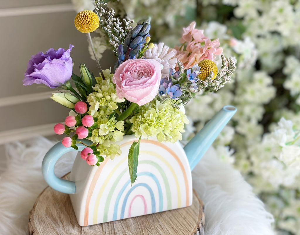 Good day flower arrangement in blue watering can